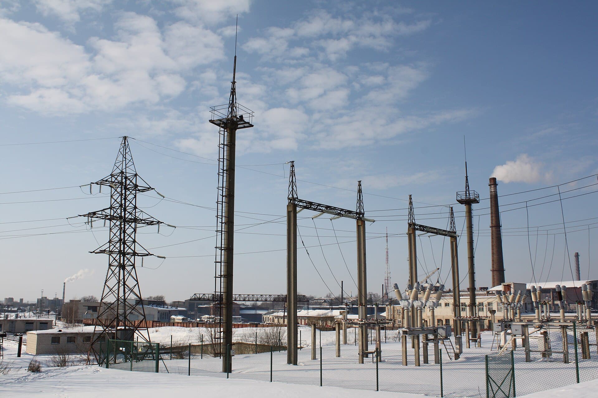 An electrical substation with transmission towers in winter.